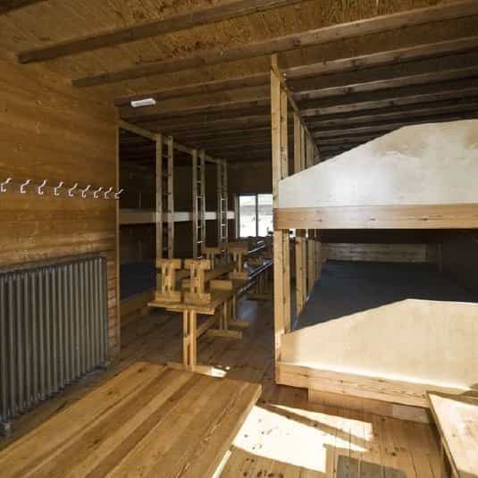 Landmannalaugar camping cabin interior with wooden bunk beds and tables