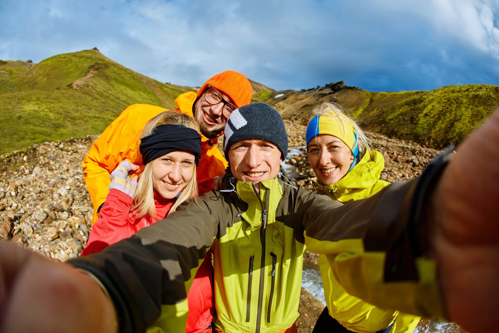 Couple of friends tourists traveling on vacation, hiking in Iceland. smiling friends hugging and posing