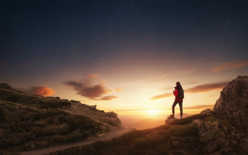 Northern lights and young woman on mountain peak at night. Auror