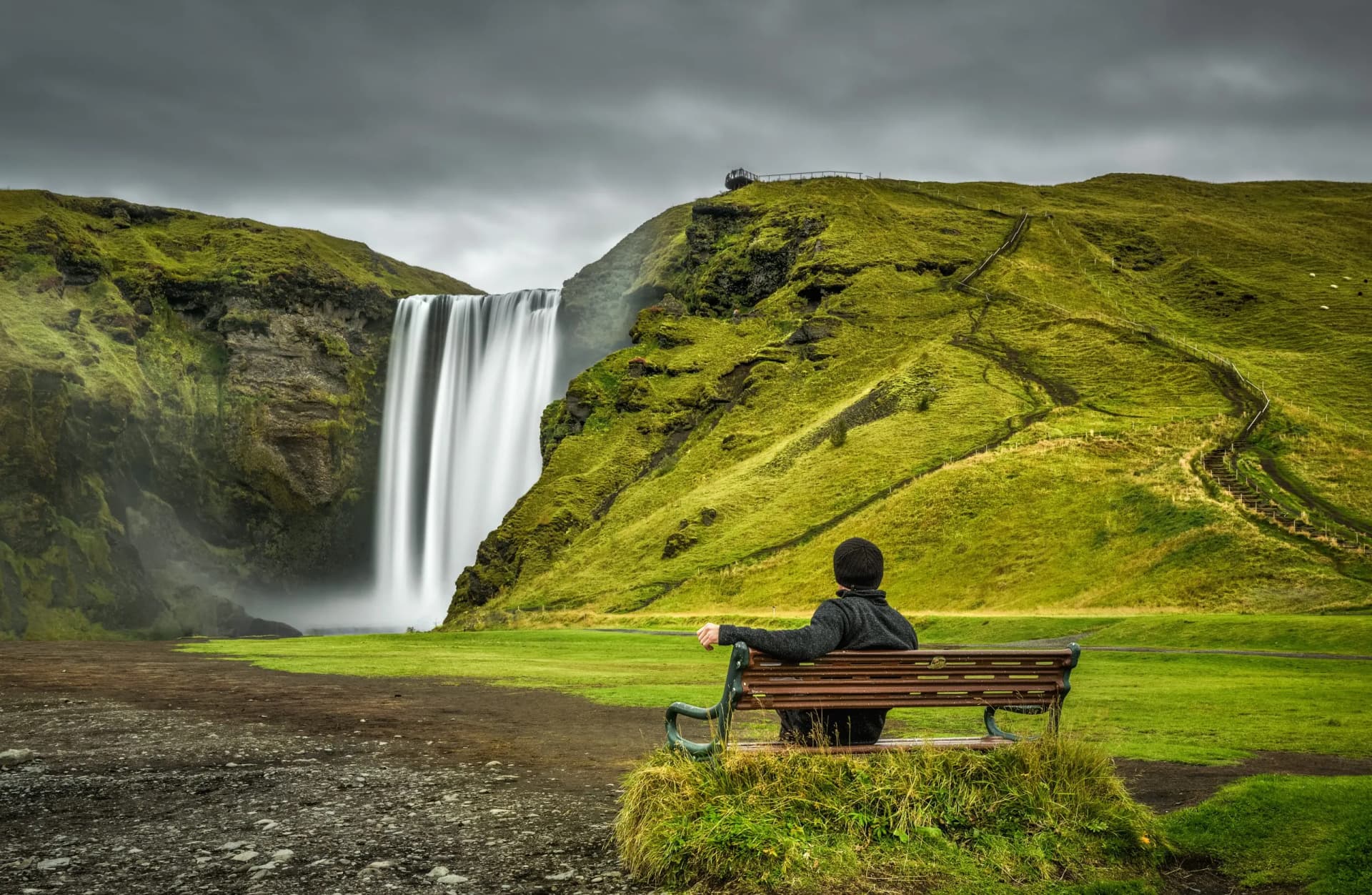 Hiker at the Skogafoss waterfall in southern Iceland
